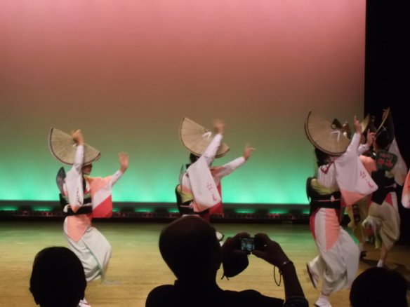 Three female dancers, dressed as the dancer in the first photo in this post, are moving from left to right in a line
